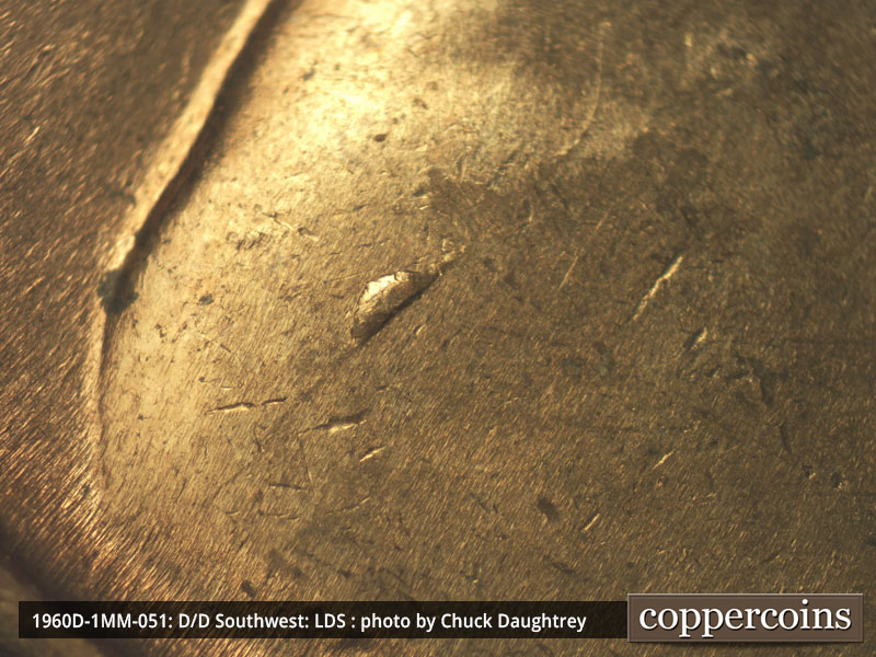 Die-stage C marker on 1960D•1MM•051 showing Die chip and crack on shoulder.