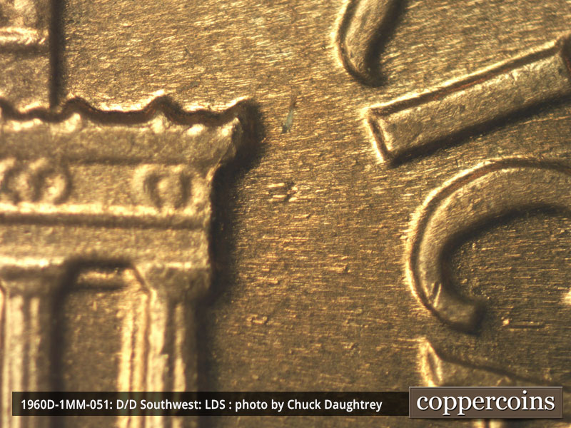 Die-stage C marker on 1960D•1MM•051 showing Die dot east of right cornice.