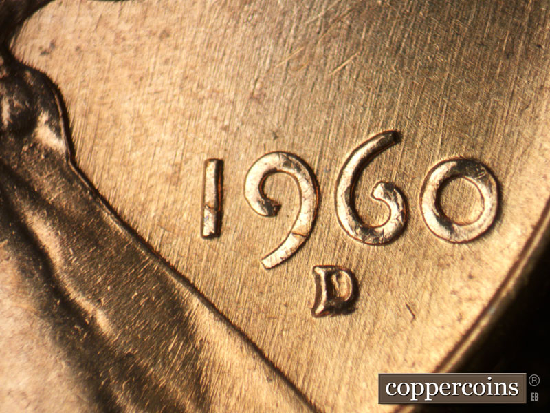 Die-stage B marker on 1960D•1MM•053 showing NNE/SSW die scratches through date.
