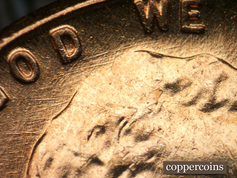 Die-stage B marker on 1960D•1MM•053 showing Die scratches throughout top of obverse.