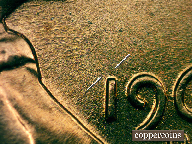 Die-stage C marker on 1960D•1MM•053 showing Pair of NW die scratches form a v shape from 9 in date. Other NW die scratches worn away from MDS.