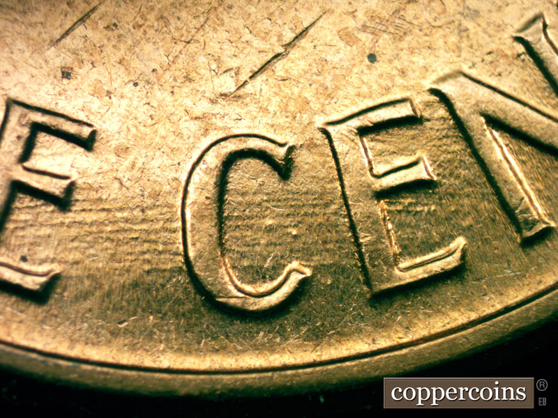 Die-stage C marker on 1960D•1MM•053 showing Multiple worn E/W die scratches on lower part of reverse.