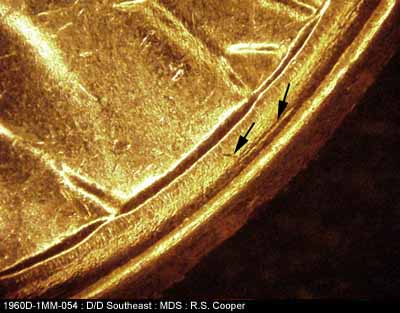 Die-stage B marker on 1960D•1MM•054 showing Die scratches between rim and bottom of bust.