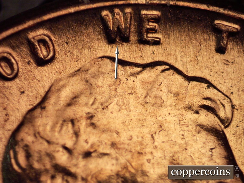 Die-stage C marker on 1960D•1MM•054 showing Die gouge in W of WE.