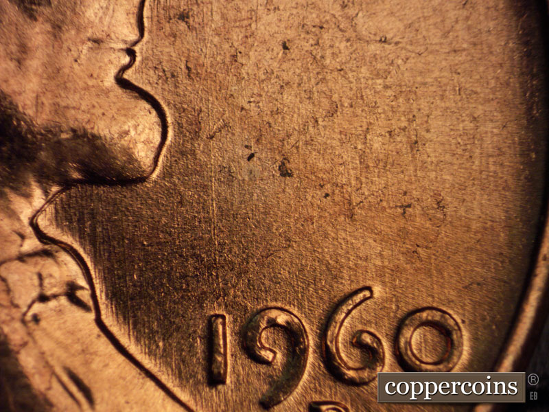 Die-stage C marker on 1960D•1MM•054 showing N/S die scratches above date.