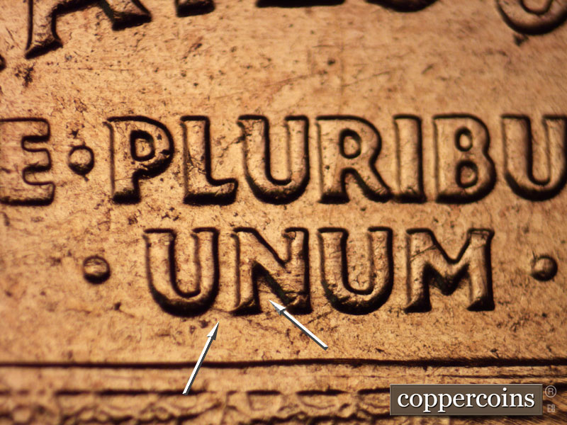 Die-stage C marker on 1960D•1MM•054 showing SE die scratch from first U in UNUM.