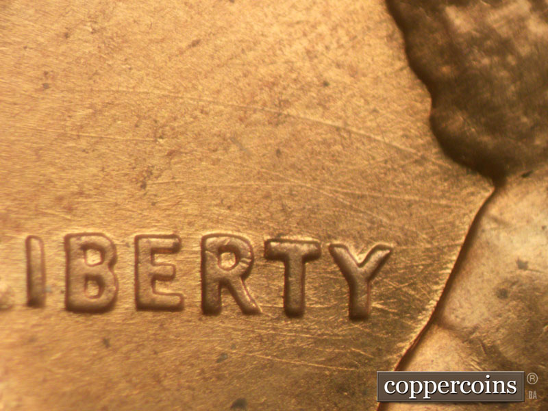 Die-stage B marker on 1960D•1MM•057 showing Heavy die scratches above LIBERTY.