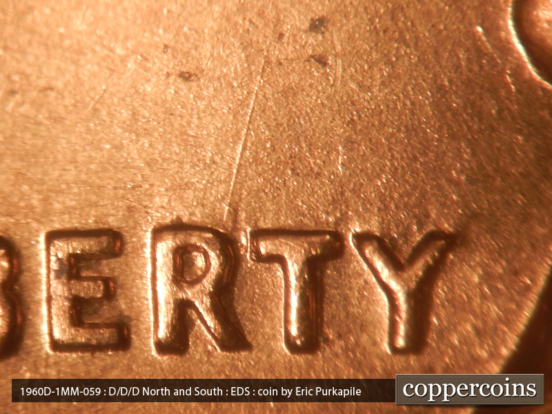 Die-stage A marker on 1960D•1MM•059 showing A die scratch runs NNE from the R in LIBERTY.