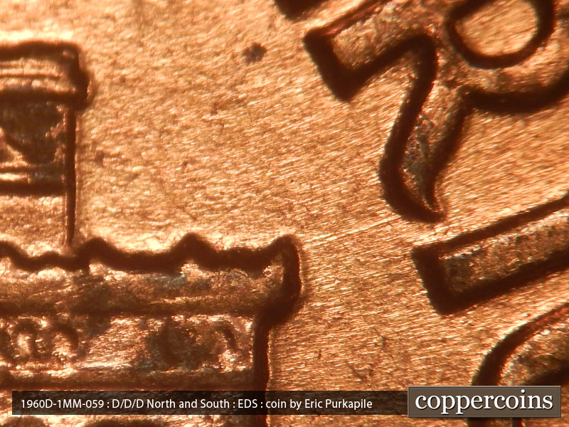 Die-stage A marker on 1960D•1MM•059 showing A die scratch extends from the right cornice to the R in AMERICA.