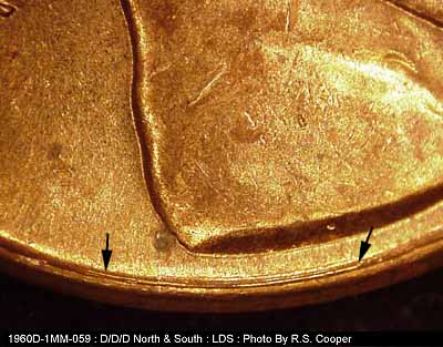 Die-stage C marker on 1960D•1MM•059 showing Concentric sie scratches under the left side of the bust.