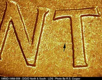 Die-stage C marker on 1960D•1MM•059 showing A short E-W die scratch from the left side of the T in CENT.