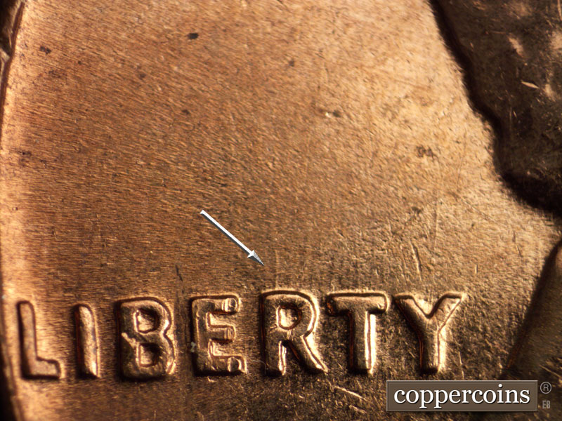 Die-stage C marker on 1960D•1MM•060 showing N/S die scrathes from the top of RTY in LIBERTY.
