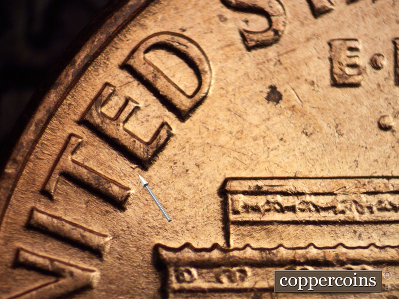 Die-stage C marker on 1960D•1MM•060 showing Die gouge on E in WNITED.