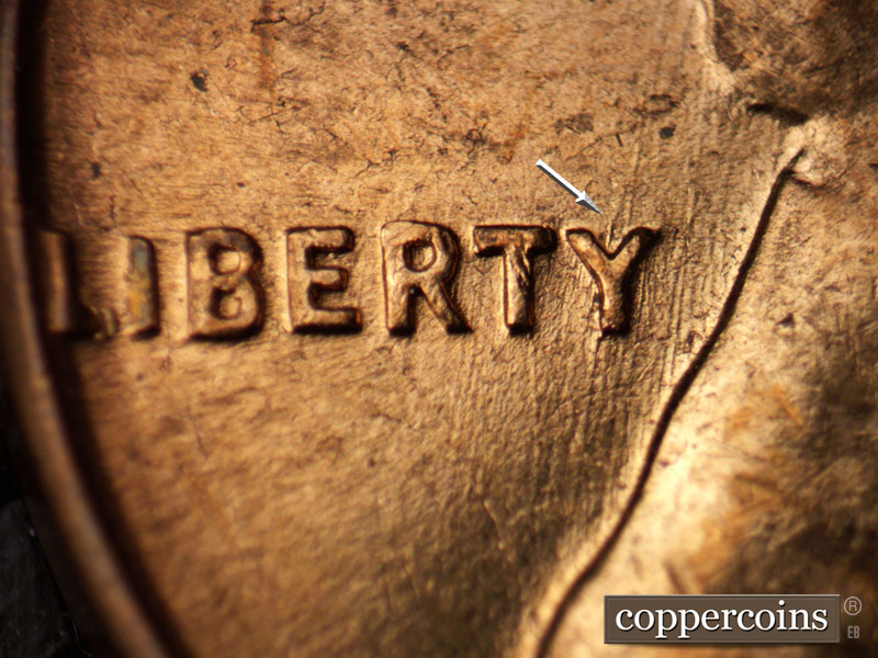 Die-stage B marker on 1960D•1MM•061 showing NNE die scratches through RTY in LIBERTY.