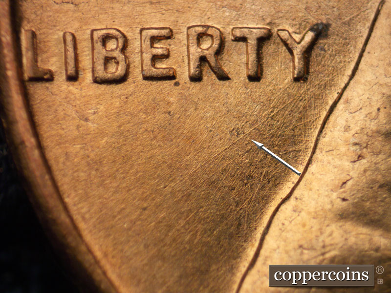 Die-stage A marker on 1960D•1MM•063 showing SW die scratch under RTY in LIBERTY.