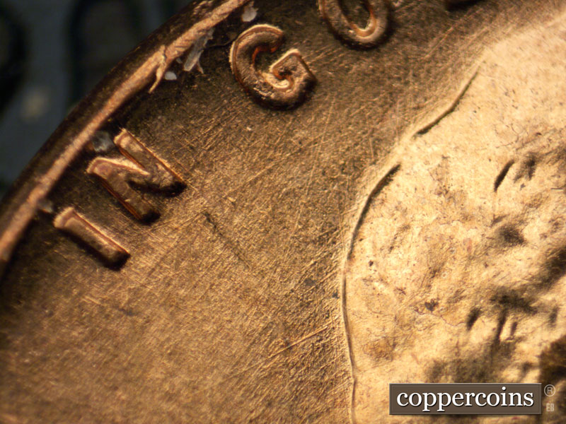Die-stage A marker on 1960D•1MM•063 showing ENE die scratch under G in GOD.