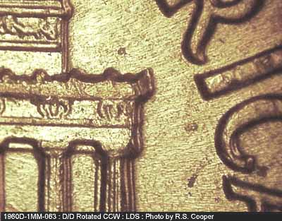 Die-stage C marker on 1960D•1MM•063 showing Die crack on right cornice edge.
