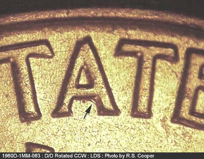 Die-stage C marker on 1960D•1MM•063 showing Die scratch under the crossbar of the A in STATES.