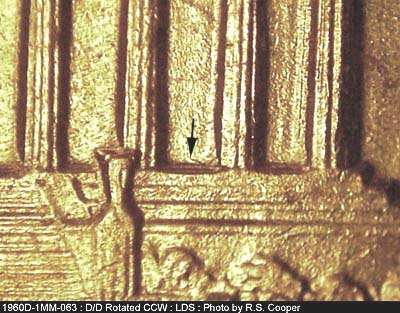 Die-stage C marker on 1960D•1MM•063 showing Very small die scratch showing in lower bay east of right planter box.