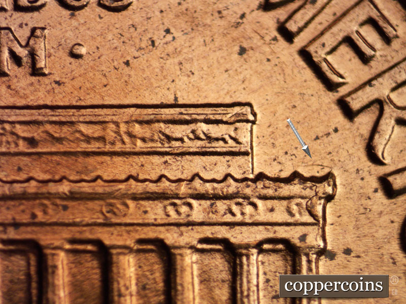 Die-stage A marker on 1960D•1MM•064 showing Depression above right cornice. Die break on right cornice.