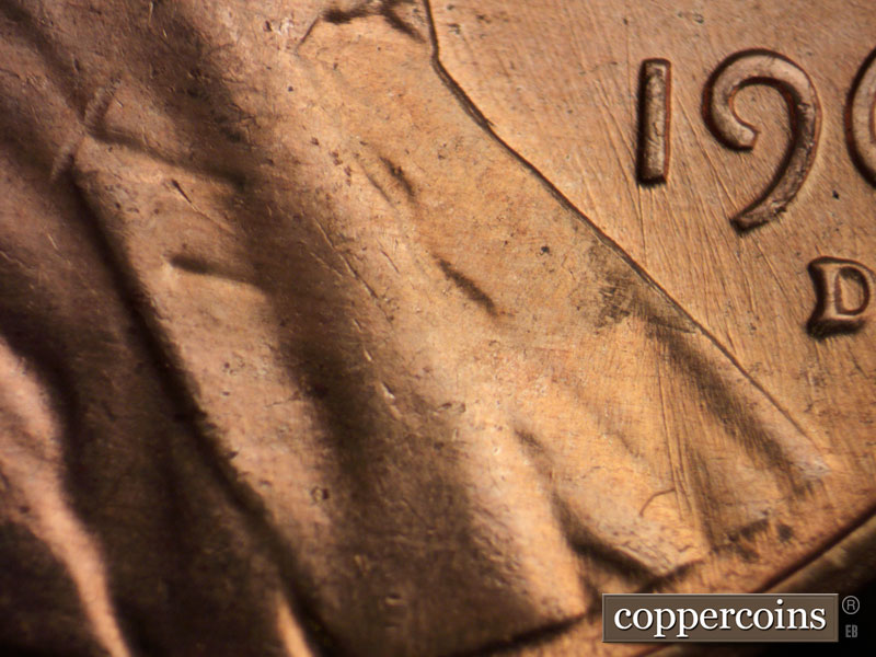 Die-stage C marker on 1960D•1MM•072 showing N/S die scratches on lower lapel.