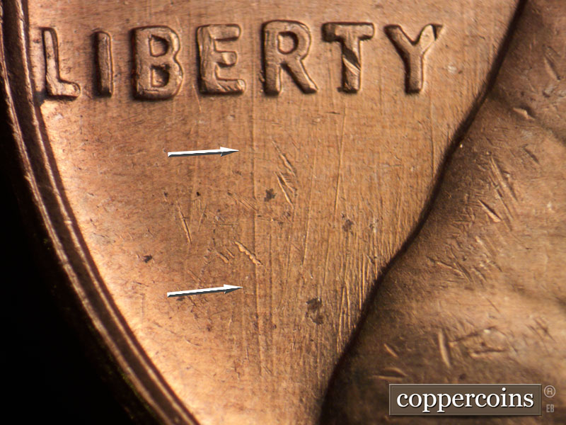 Die-stage C marker on 1960D•1MM•072 showing Heavy N/S die scratch from between ER in LIBERTY heading toward rim.