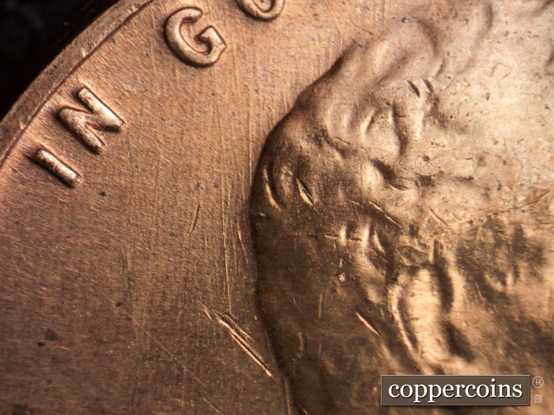 Die-stage C marker on 1960D•1MM•072 showing N/S die scratches behind head.