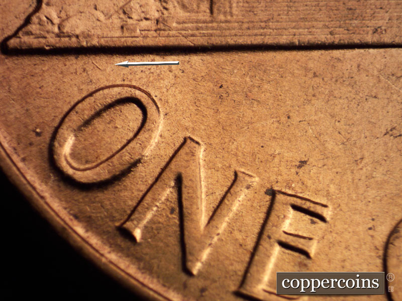 Die-stage A marker on 1960D•1MM•073 showing Small die gouge from left base toward O in ONE.