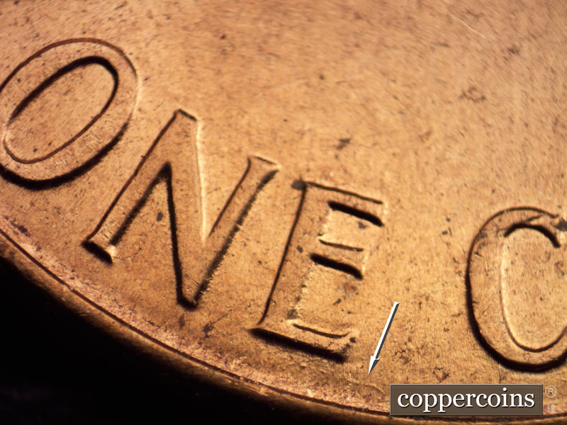 Die-stage A marker on 1960D•1MM•073 showing Die scratch between rim and botton of E in ONE.