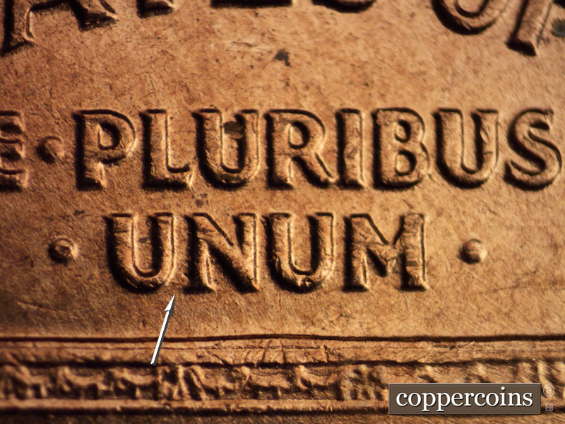 Die-stage B marker on 1960D•1MM•073 showing Small die gouge between UN in UNUM.
