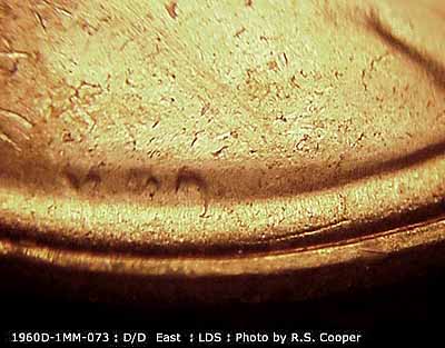 Die-stage C marker on 1960D•1MM•073 showing A die gouge runs parallel to the rim southeast of VDB.