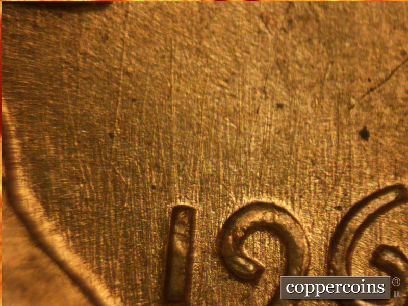 Die-stage B marker on 1960D•1MM•077 showing N/S die scratches through the date and LIBERTY. Die scratches on the jacket and central lapel areas.