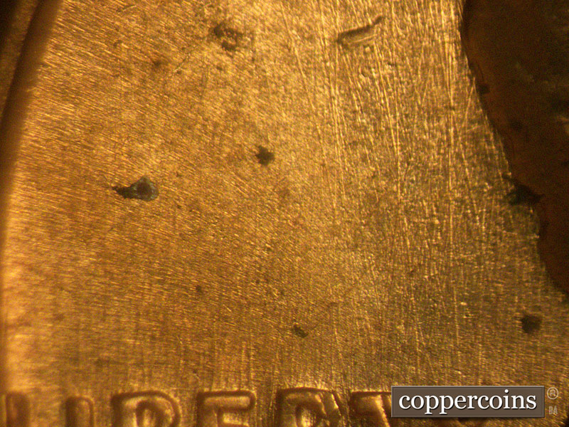 Die-stage B marker on 1960D•1MM•077 showing N/S die scratches through LIBERTY.