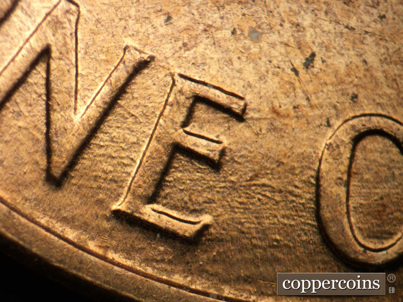 Die-stage B marker on 1960D•1MM•117 (1960 Repunched Mint Mark).