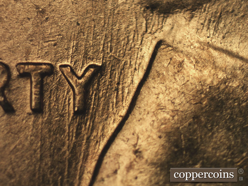 Die-stage B marker on 1960D•1MM•158 showing NNE die scratches through Y in LIBERTY.