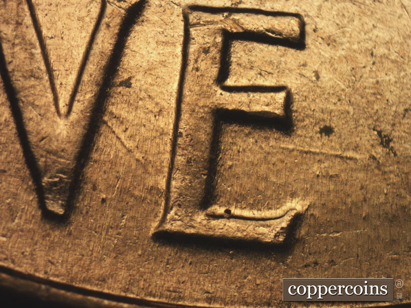 Die-stage B marker on 1960D•1MM•158 showing Die gouge in lower E in ONE.