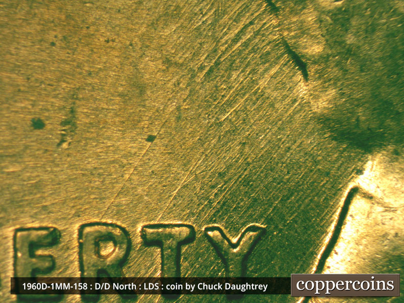 Die-stage D marker on 1960D•1MM•158 showing SW die scratches from back of hair into RTY of LIBERTY.