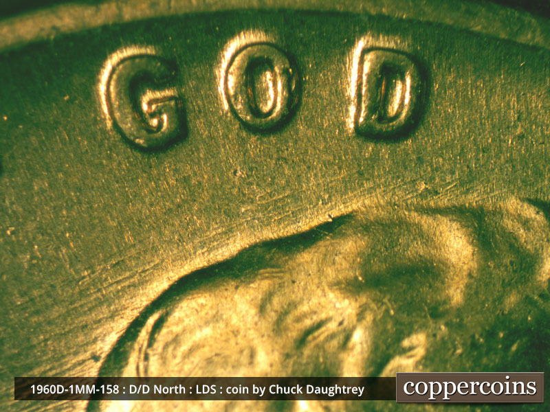 Die-stage D marker on 1960D•1MM•158 showing WSW die scratches under GOD.