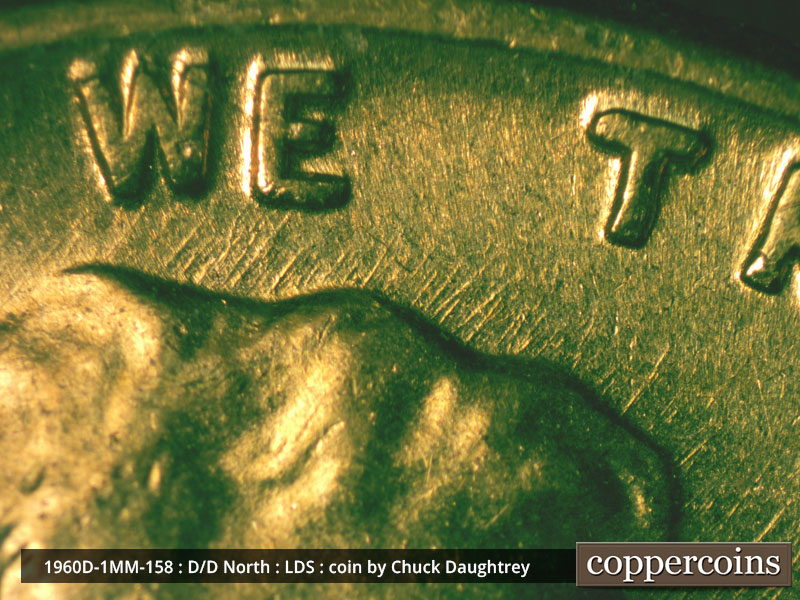 Die-stage D marker on 1960D•1MM•158 showing NE die scratches from top of heair into WE.