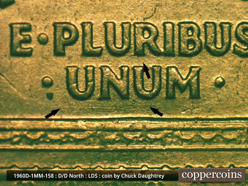 Die-stage D marker on 1960D•1MM•158 showing E/W die scratches under UNU in UNUM.