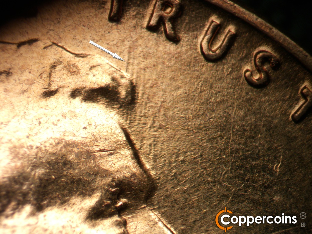 Die-stage C marker on 1960D•1MM•158 showing Worn N/S die gouge from front tip of hair.