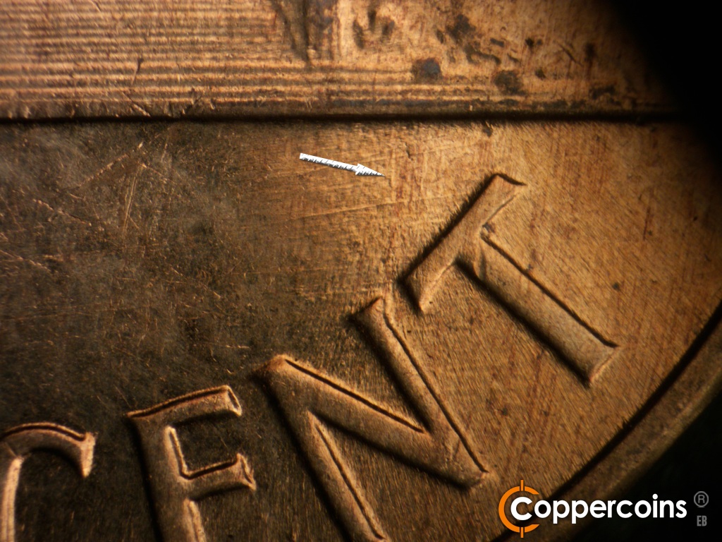 Die-stage C marker on 1960D•1MM•158 showing Worn N/S die gouge still visible from stage B. Generally E/W di scratches above CENT.