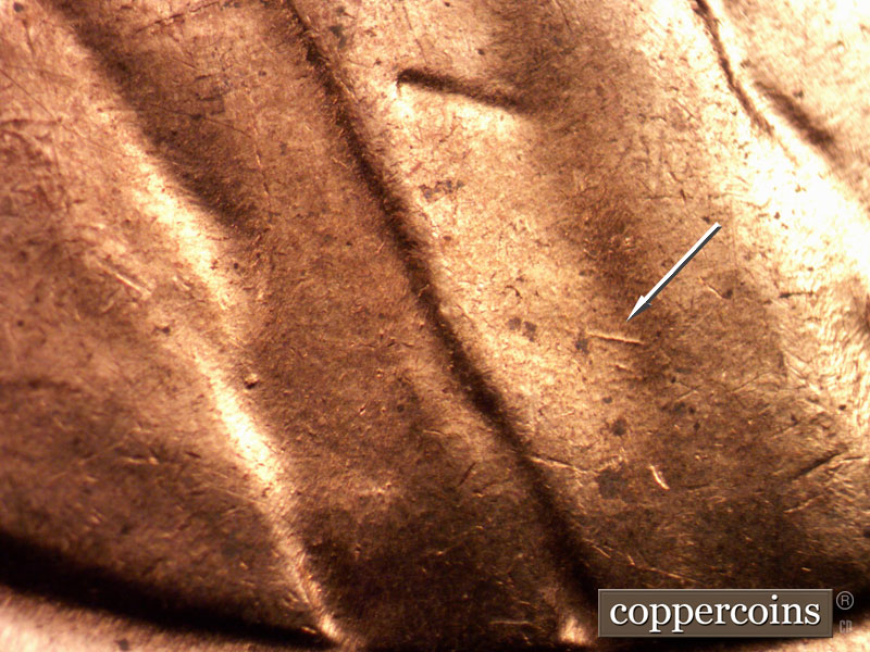 Die-stage C marker on 1960D•1MM•163 showing ESE die scratch on lapel.
