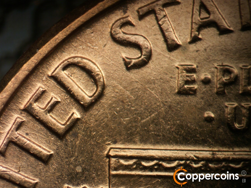 Die-stage A marker on 1960D•1MM•163 showing NW die scratches from E in E PLURIBUS into Sfirst S in STATES.