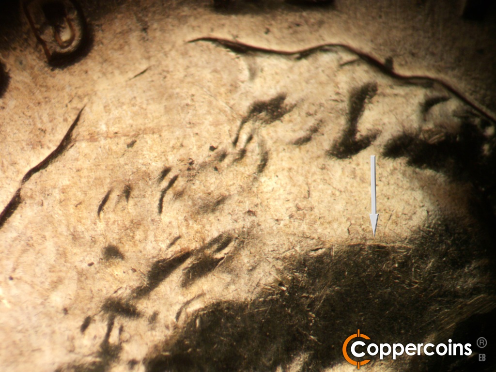 Die-stage A marker on 1960D•1MM•173 showing Die crack starting to form on forehead.