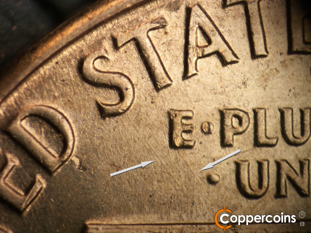 Die-stage A marker on 1960D•1MM•173 showing Die scratch from first S in STATES to roof. Die scratches intersect below E in E PLURIBUS.