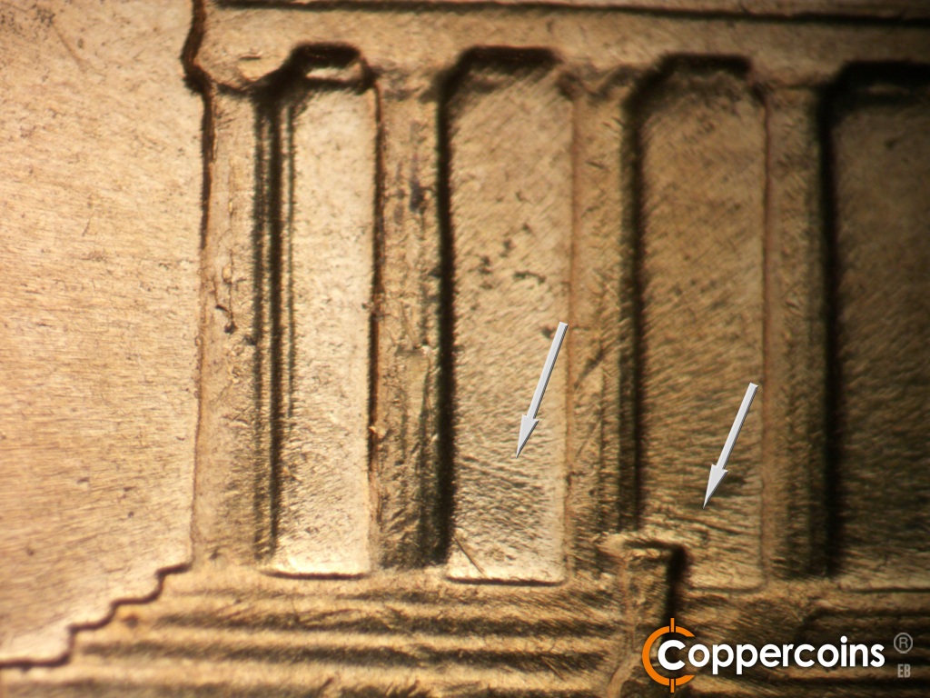 Die-stage A marker on 1960D•1MM•173 showing ESE die scratches through bays 2 and 3. DLight die chipping on column 1.