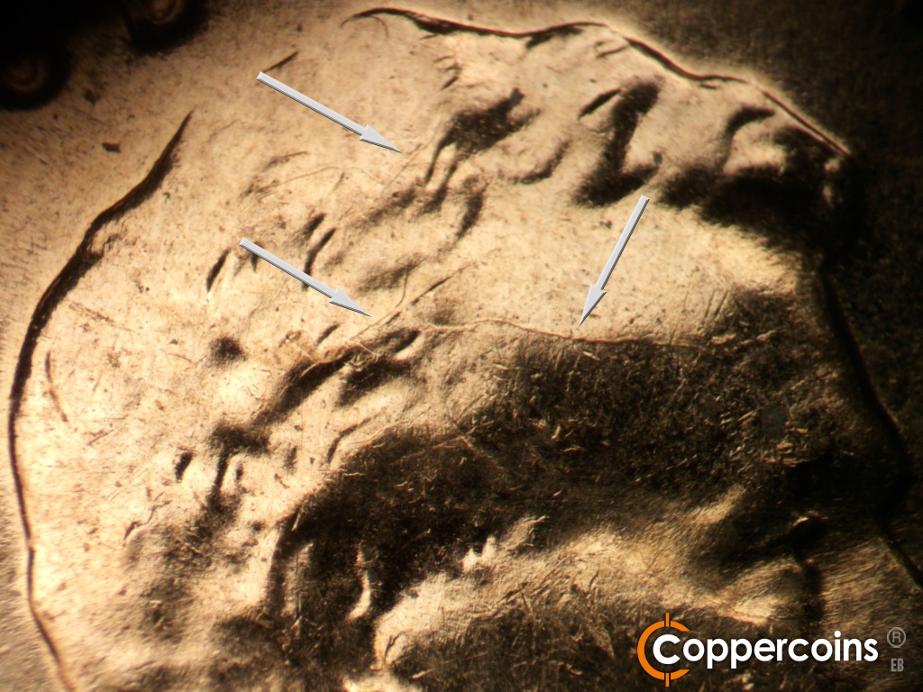 Die-stage B marker on 1960D•1MM•173 showing Die cracks in hair and across forehead.
