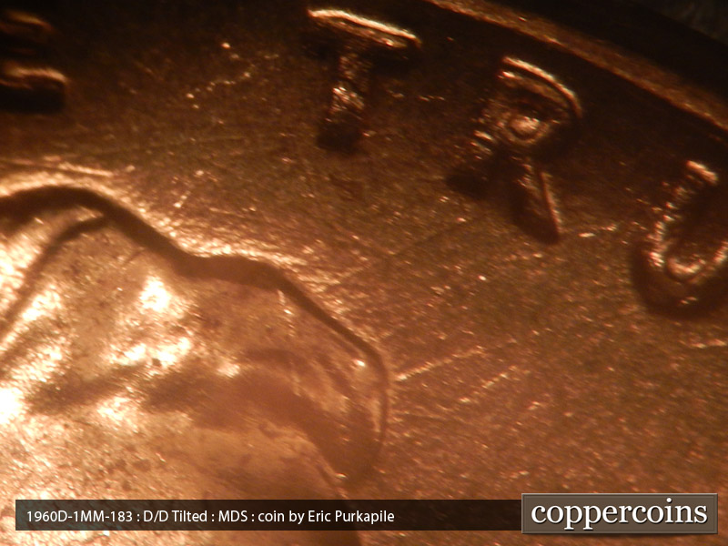 Die-stage B marker on 1960D•1MM•183 showing Die scratches extend from the hair above the forehead into the field.
