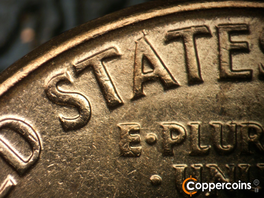 Die-stage C marker on 1960D•1MM•183 showing Die scratch under the right crossbar of the first T in STATES is worn.